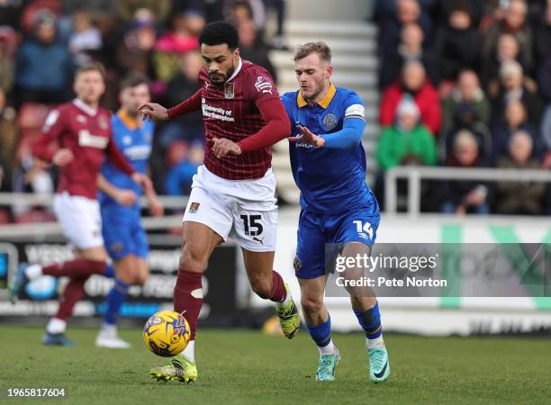 Jordan Willis of Northampton Town moves forward with the ball away from Taylor Perry of Shrewsbury Town during the Sky Bet League One match between...