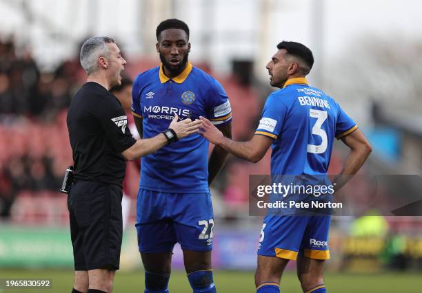 Chey Dunkley and Mal Bennning of Shewsbury Town look on as referee Sebastian Stockbridge makes a point during the Sky Bet League One match between...