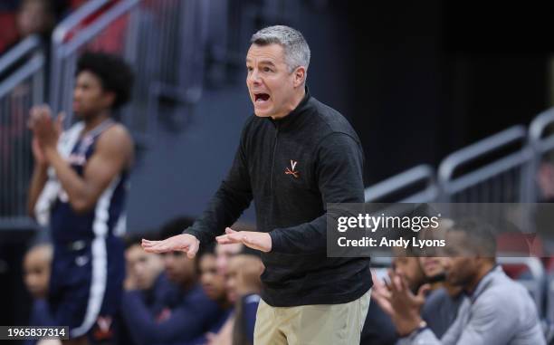 Tony Bennett the head coach of the Virginia Cavaliers gives instructions to his team in the game against the Louisville Cardinals at KFC YUM! Center...