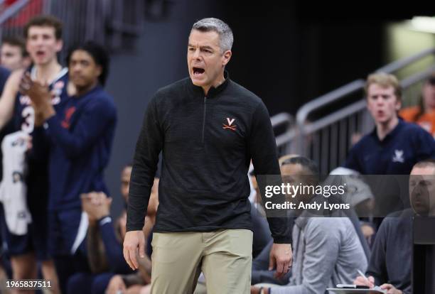 Tony Bennett the head coach of the Virginia Cavaliers gives instructions to his team in the game against the Louisville Cardinals at KFC YUM! Center...