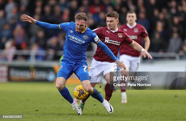 Carl Winchester of Shrewsbury Town contests the ball with Sam Hoskins of Northampton Town during the Sky Bet League One match between Northampton...