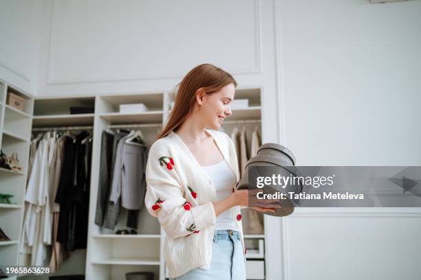 in a dressing room, smiling long-haired woman stands with clothing and accessories boxes - collection backstage stock pictures, royalty-free photos & images