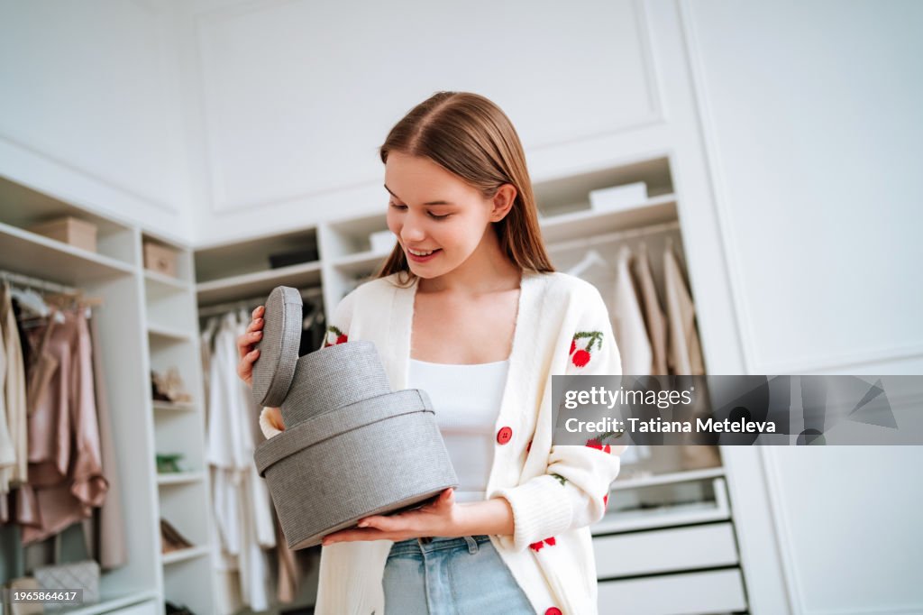 Woman opening textile boxes in walk-in closet, preparing for the day