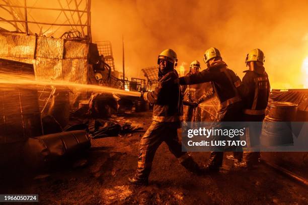 Firemen extinguish a fire in the Makadara area of Nairobi on January 30, 2024. A huge fire broke in the evening of January 30, 2024 in the area of...