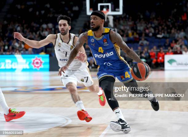 Real Madrid's Argentinian guard Facundo Campazzo vies with Maccabi's US guard Lorenzo Brown during the Euroleague round 24 basketball match between...