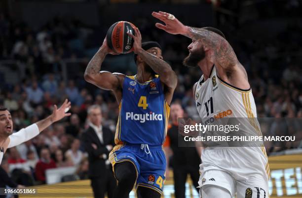 Real Madrid's French center Vincent Poirier vies with Maccabi's US guard Lorenzo Brown during the Euroleague round 24 basketball match between Real...