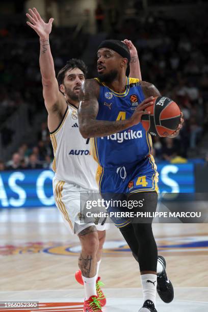 Real Madrid's Argentinian guard Facundo Campazzo vies with Maccabi's US guard Lorenzo Brown during the Euroleague round 24 basketball match between...