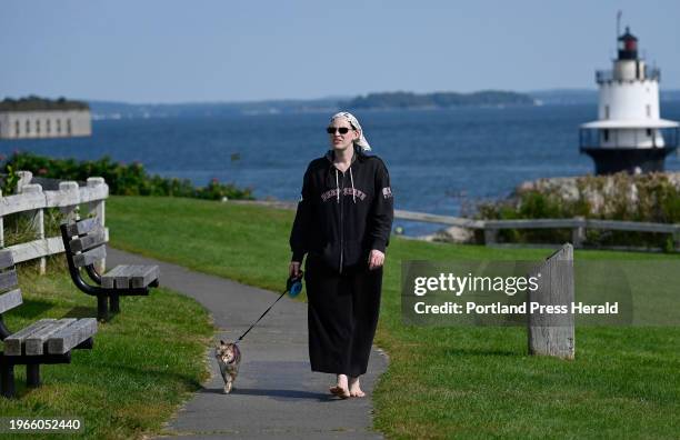 September 27: Grace Relihan of Pownal walks with her cat Sole' on the Spring Point Shoreway Trail at Fort Preble in South Portland Wednesday,...