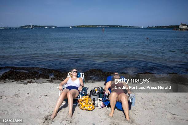 Lauren Coughlin, left, Hannah Keating, both of Portland, lay in the sun at Willard Beach on Friday, July 7, 2023. Friday was another hot, summer day...