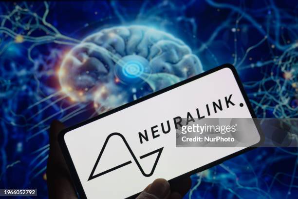 The Neuralink logo is being displayed on a smartphone with a brain chip visible in the background in this photo illustration in Brussels, Belgium, on...