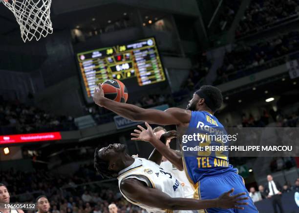 Real Madrid's Spanish forward Eli Ndiaye vies with Maccabi's US center Josh Nebo during the Euroleague round 24 basketball match between Real Madrid...