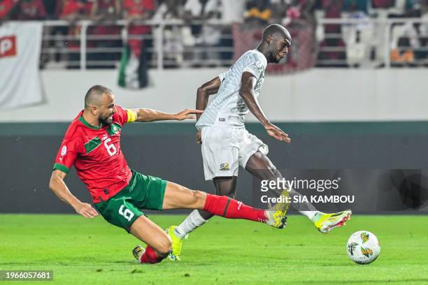 South Africa's forward Evidence Makgopa shoots the ball to score a goal as Morocco's defender Romain Saiss tries to stop him during the Africa Cup of...