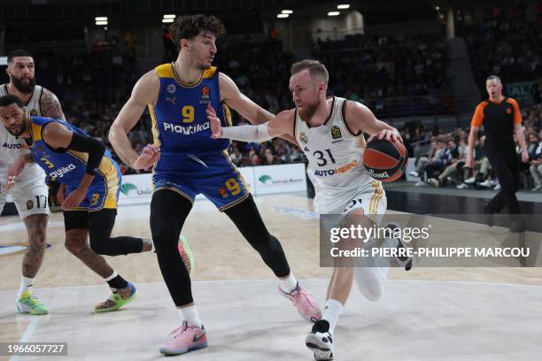 Real Madrid's Bosnian forward Dzanan Musa vies with Maccabi's Israelian forward Roman Sorkin during the Euroleague round 24 basketball match between...