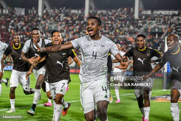 South Africa's midfielder Teboho Mokoena celebrates with teammates after scoring a goal during the Africa Cup of Nations 2024 round of 16 football...
