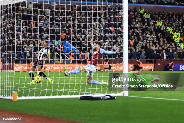 Jacob Murphy of Newcastle United shoots but the ball comes off Alex Moreno of Aston Villa for an own goal during the Premier League match between...