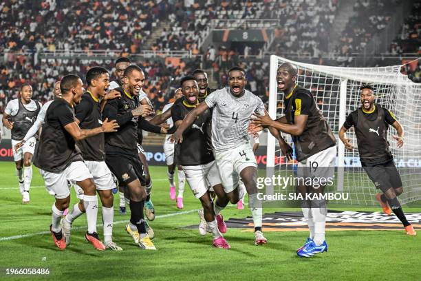 South Africa's midfielder Teboho Mokoena celebrates with teammates after scoring a goal during the Africa Cup of Nations 2024 round of 16 football...