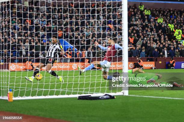 Jacob Murphy of Newcastle United shoots but the ball comes off Alex Moreno of Aston Villa for an own goal during the Premier League match between...