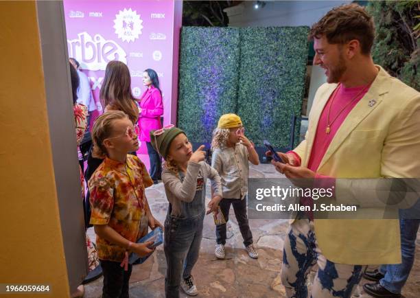 Westwood, CA Tommy Korn, right, records Lavern Korn left, Ayla Korn middle, and Gray Korn signing as they arrive to attend the US. Deaf West and Max...