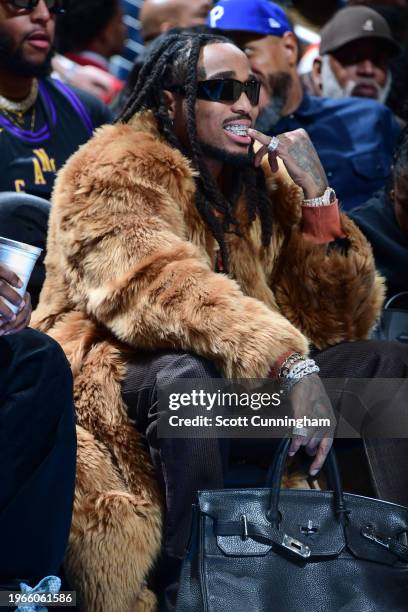 Quavo sits courtside during the game on January 30, 2024 at State Farm Arena in Atlanta, Georgia. NOTE TO USER: User expressly acknowledges and...
