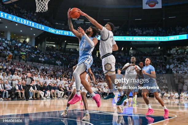 Georgia Tech guard Kyle Sturdivant blocks the shot of North Carolina guard RJ Davis during the college basketball game between the North Carolina Tar...