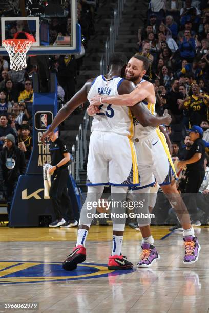 Stephen Curry of the Golden State Warriors & Draymond Green of the Golden State Warriors embrace during the game on January 30, 2024 at Chase Center...