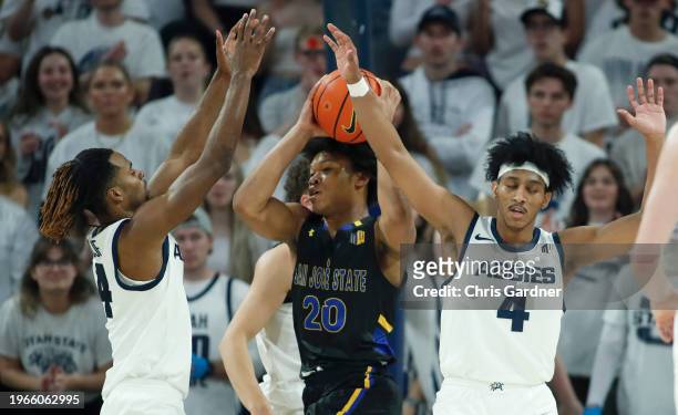 Josh Uduje and Ian Martinez of the Utah State Aggies trap Christian Wise of the San Jose State Spartans during the second half at the Dee Glen...