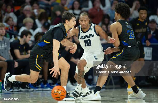 Darius Brown II of the Utah State Aggies is picked by Christian Wise of the San Jose State Spartans as Alvaro Cardenas drives past during the second...