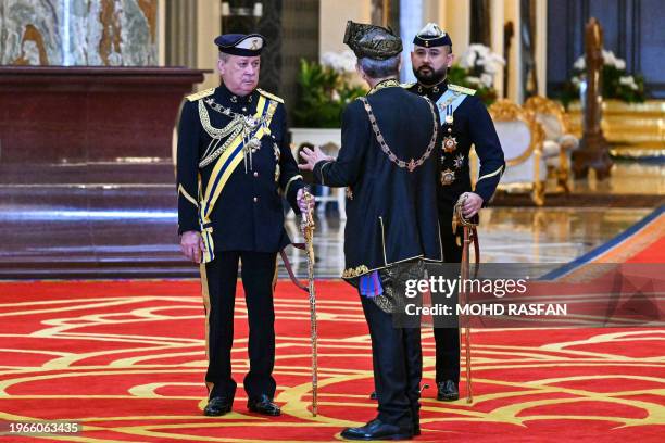 King of Malaysia Sultan Ibrahim Iskandar speaks with Crown Prince Ismail Sultan Ibrahim of Johor after the oath taking ceremony at the National...