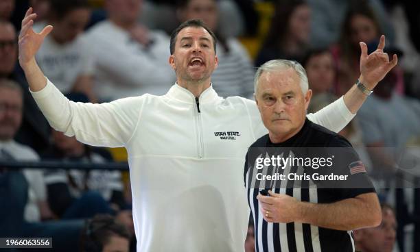 Head coach Danny Sprinkle of the Utah State Aggies argues a call with referee Randy McCall during the second half against the San Jose State Spartans...