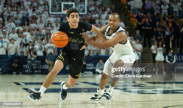 Alvaro Cardenas of the San Jose State Spartans pushes the ball past Darius Brown II of the Utah State Aggies during the first half at the Dee Glen...