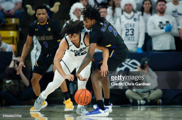 Rickey Mitchell Jr., #2 of the San Jose State Spartans knocks the ball from Javon Jackson of the Utah State Aggies in the first half at the Dee Glen...