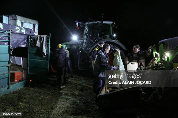 Farmers of the CR47 union pack their belongings before resuming their Paris-bound convoy after an overnight stop-over in Pierrefitte-sur-Sauldre,...