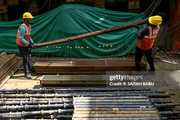 Labourers work at the 'Chennai Metro Rail project' construction site in Chennai on January 31, 2024.