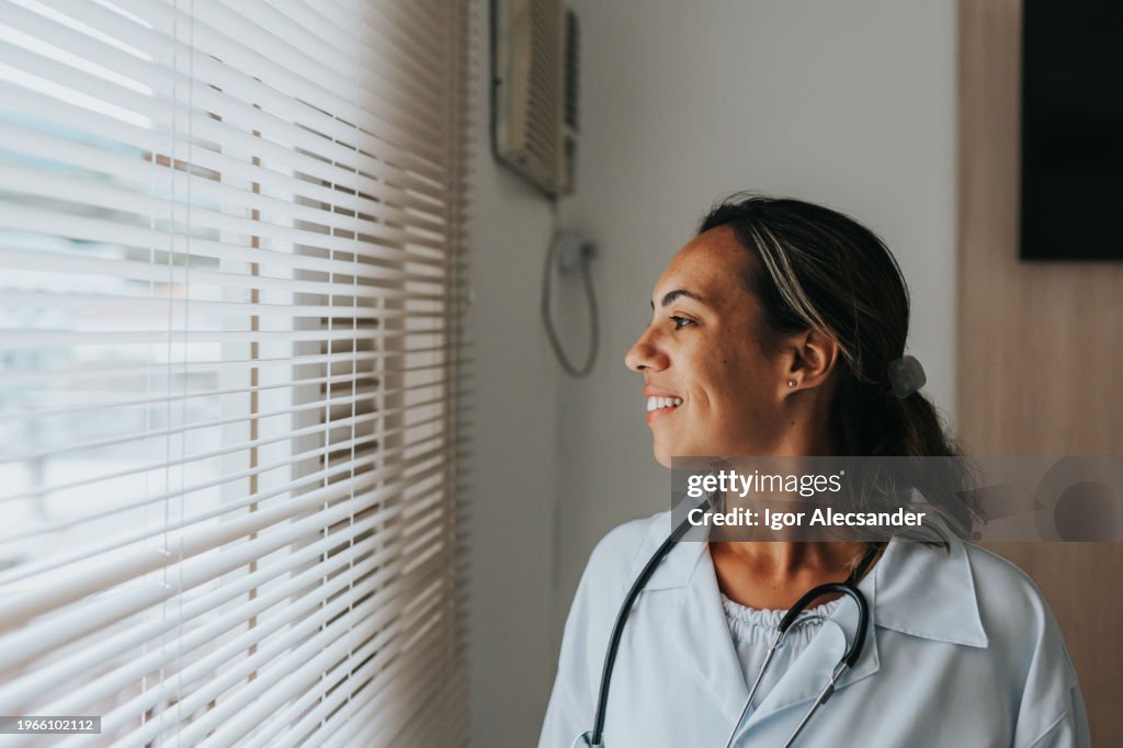 Friendly female doctor at the hospital window