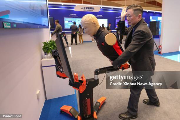 Staff member demonstrates a digital first aid educational device for campus during the 2024 World Digital Education Conference in Shanghai, east...