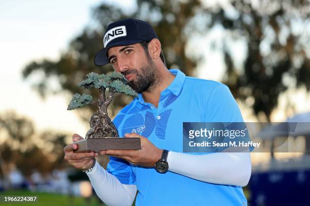 Matthieu Pavon of France kisses the trophy after winning the Farmers Insurance Open at Torrey Pines South Course on January 27, 2024 in La Jolla,...