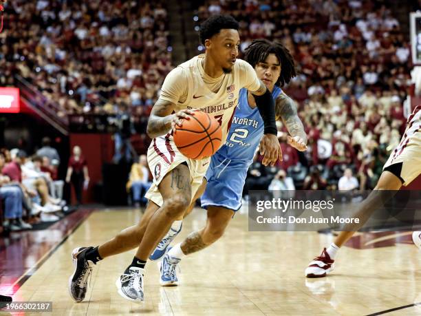 Primo Spears of the Florida State Seminoles is defended by Elliot Cadeau of the North Carolina Tar Heels during the game at the Donald L. Tucker...