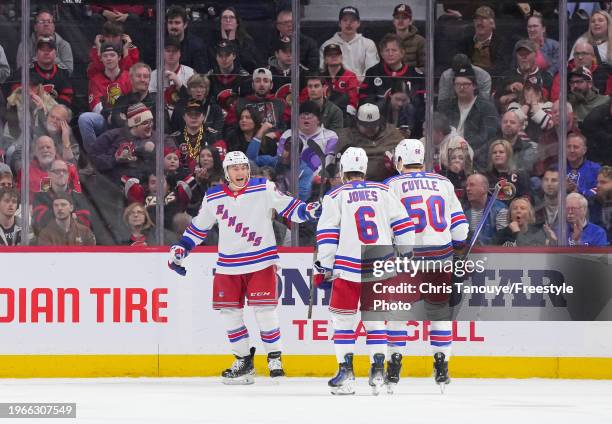 Jonny Brodzinski of the New York Rangers celebrates his second period goal against the Ottawa Senators with Zac Jones and Will Cuylle at Canadian...