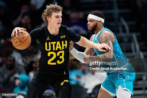 Miles Bridges of the Charlotte Hornets guards Lauri Markkanen of the Utah Jazz in the third quarter during their game at Spectrum Center on January...