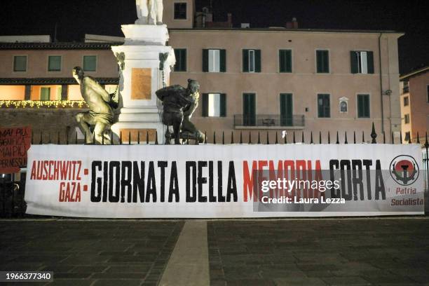 Banner that reads: 'Auschwitz Gaza. Giornata della Memoria corta' on Holocaust Remembrance Day is seen in the city centre near the Quattro Mori...