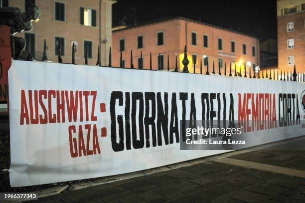 Banner that reads: 'Auschwitz Gaza. Giornata della Memoria corta' on Holocaust Remembrance Day is seen in the city centre near the Quattro Mori...