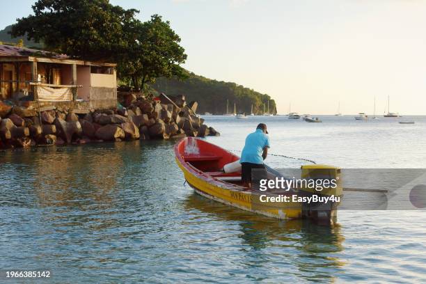 fisherman pulling fishing net - kreolische kultur stock-fotos und bilder