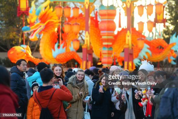 Tourists pose for a group photo at Universal Beijing Resort on January 27, 2024 in Beijing, China. Universal Beijing Resort's Chinese New Year...