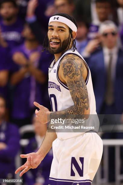 Boo Buie of the Northwestern Wildcats celebrates a three pointer against the Ohio State Buckeyes during the second half at Welsh-Ryan Arena on...