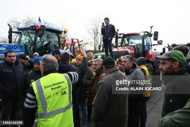 Farmers of the CR47 union gather as their Paris-bound tractor convoy is blocked by the police in Chateauneuf-sur-Loire, near Orleans, on January 31...