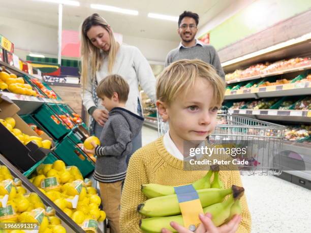 family shopping in supermarket - brunette smiling stock pictures, royalty-free photos & images
