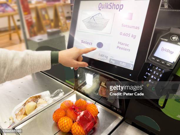 customer using self service machine in supermarket - hand fruit stock pictures, royalty-free photos & images