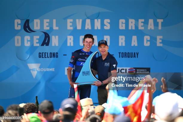 Laurence Pithie of New Zealand and Team Groupama-FDJ receives the trophy as race winner from the hands of Cadel Evans of Australia Ex- Pro-cyclist...