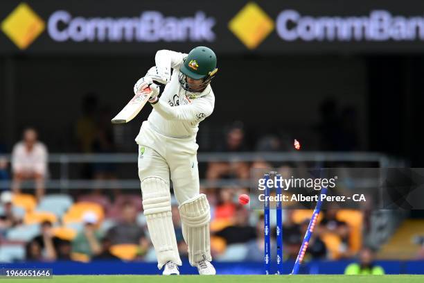 Alex Carey of Australia is bowled out by Shamar Joseph of West Indies during day four of the Second Test match in the series between Australia and...