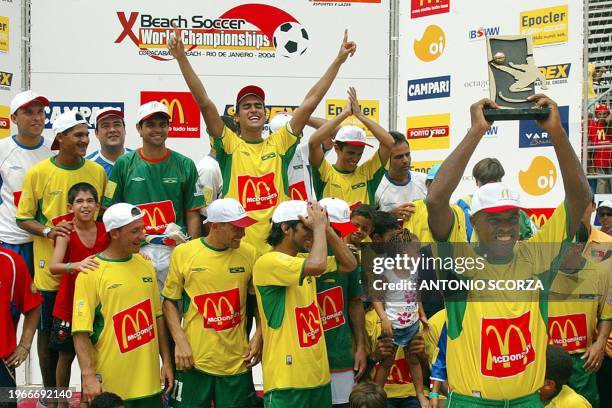 Brazilian beach-soccer players celebrate 07 March 2004, while team captain Negao raises the trophy during the Beach Soccer World Championship awards...